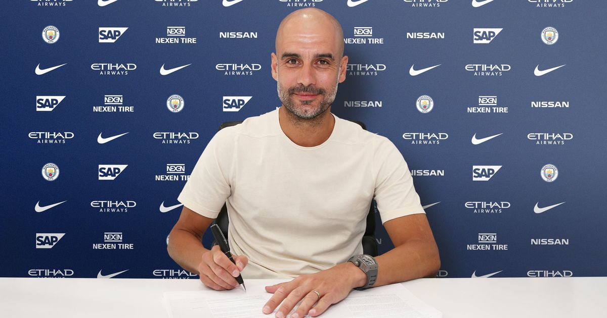 Pep-Guardiola-Signs-New-Contract-Handout-Photos.jpg