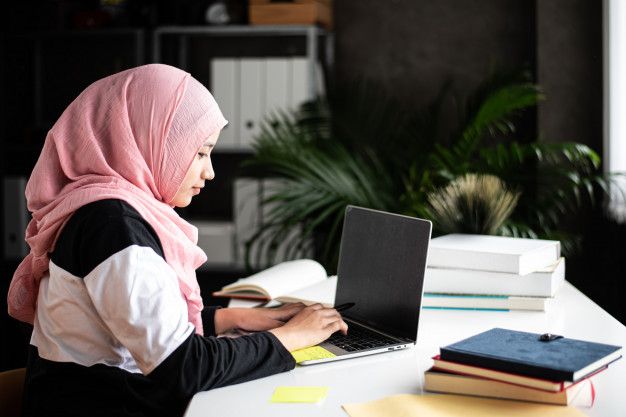 muslim-girl-doing-work-home_43403-983.jpg