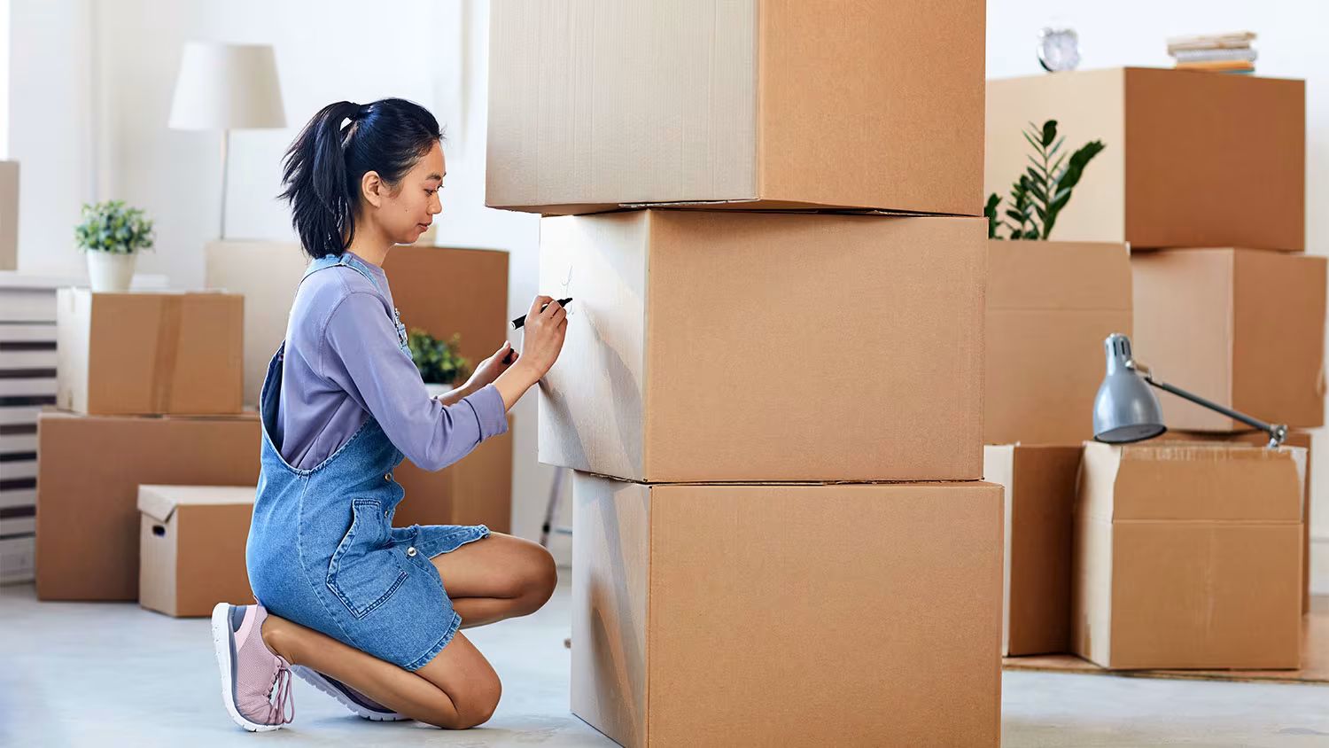 woman-labeling-moving-boxes.avif